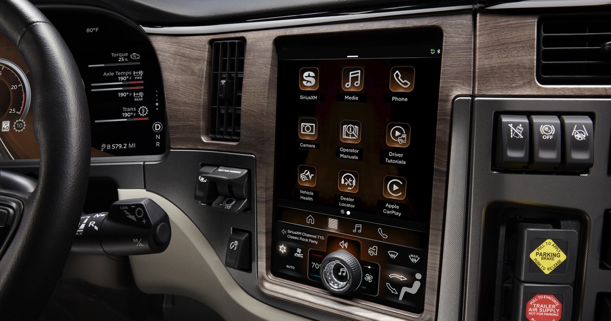 paccar-connect-featured-1200×630-1 PACCAR Connect touchscreen display in a Peterbilt truck cab showing Vehicle Health, Dealer Locator and Operator Manuals apps